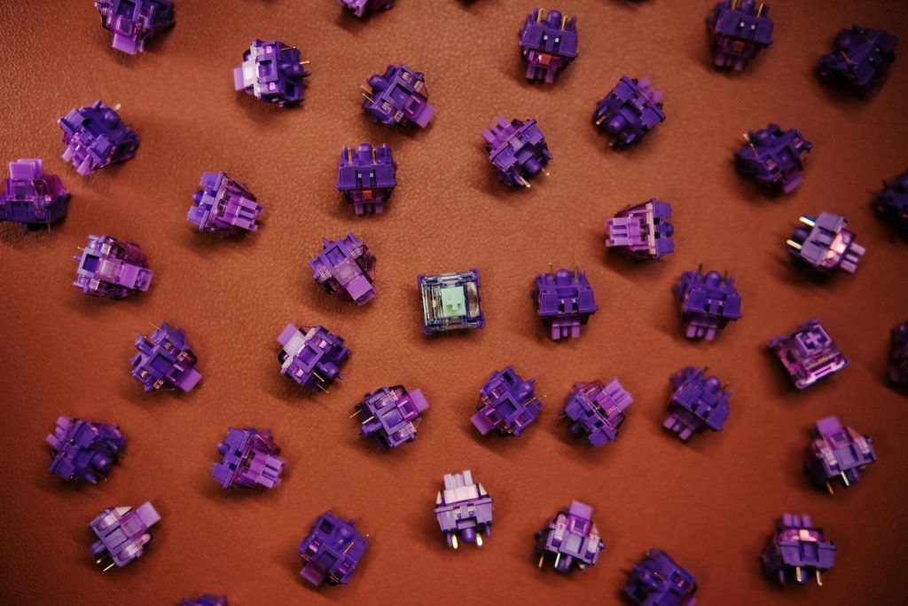 Surtido de switches en color púrpura switches scattered on a brown surface.