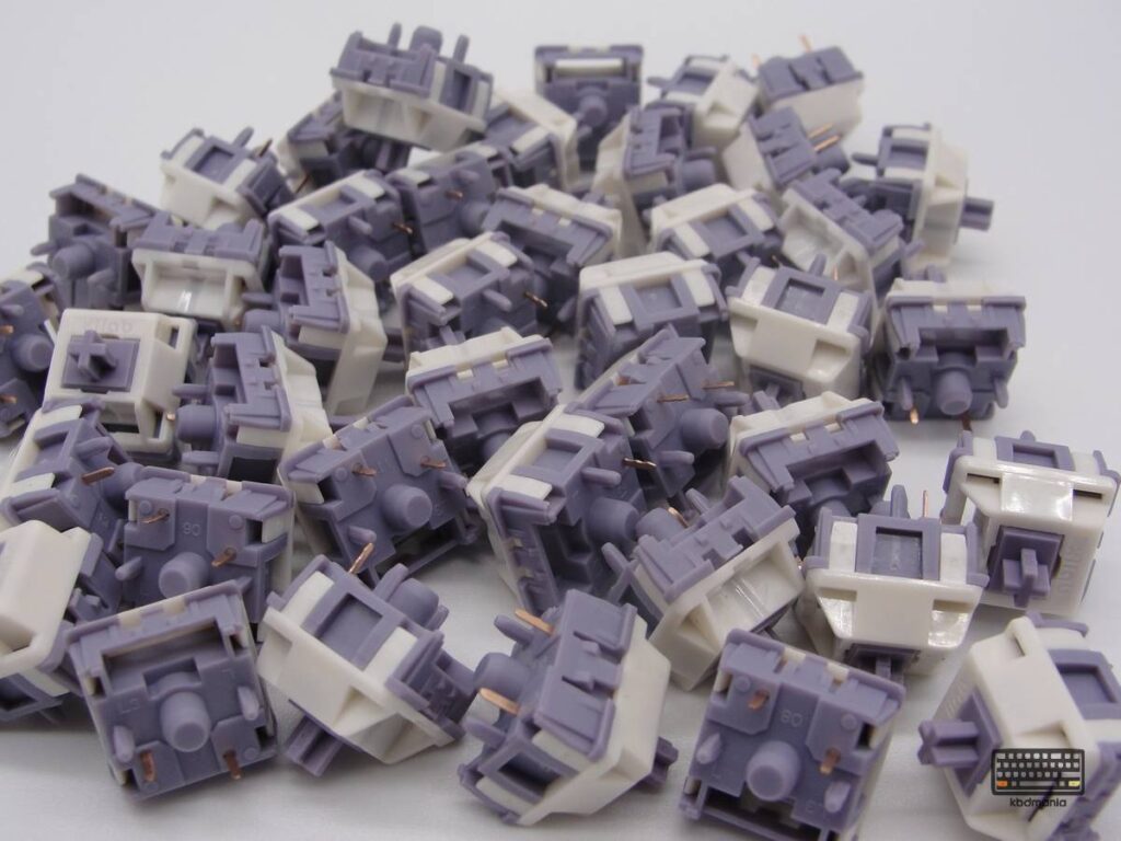 Pack de switches táctiles, 5 pines HMX Yamatake. Stem y bottom malva, top crema.