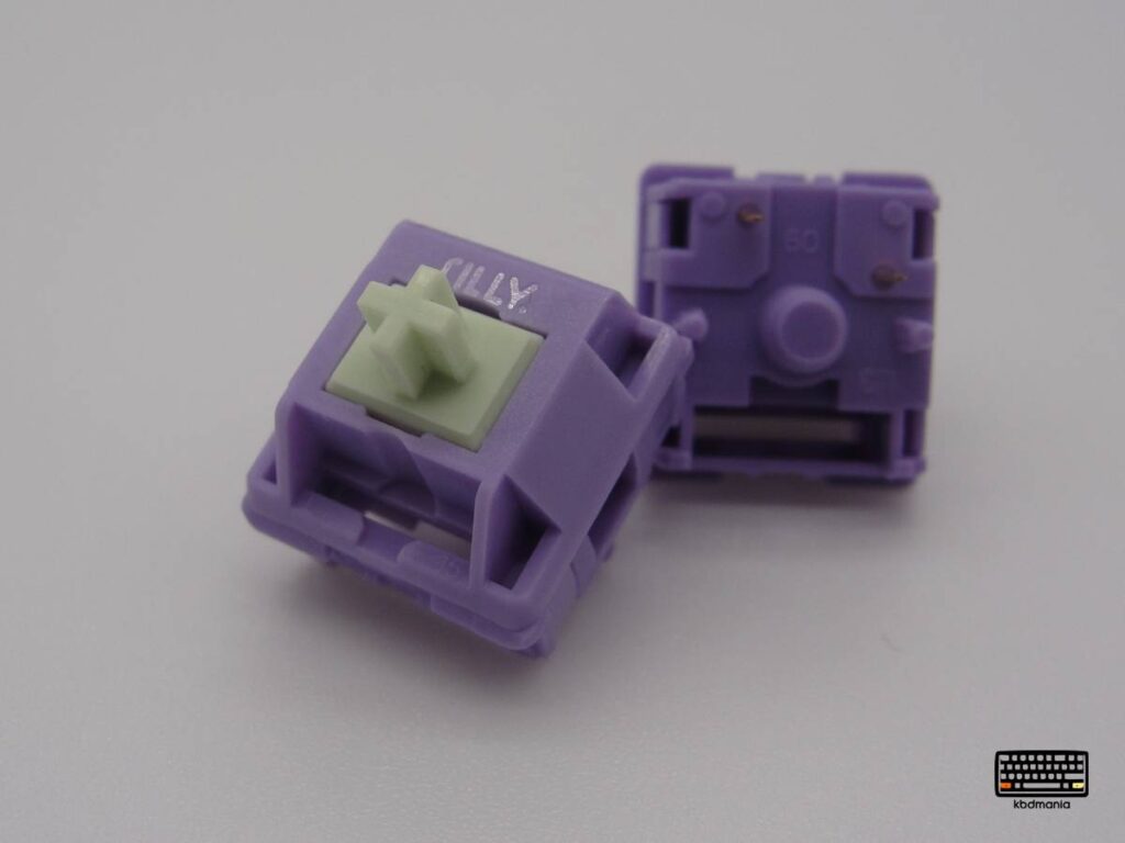 Macro 2 switches Hyacinth V2, stem verde, top y bottom violeta, vista frontal y pines de conexión.