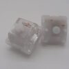 2 switches táctiles HMX Hydra, top y bottom blanco opaco, top transparente. Vista frontal y 5 pines.