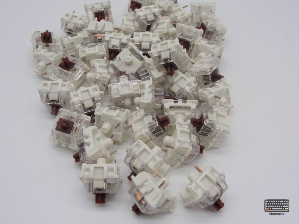 Pack switches Gateron KS-9 Brown. Stem marrón, top transparente, bottom crema. Táctiles.