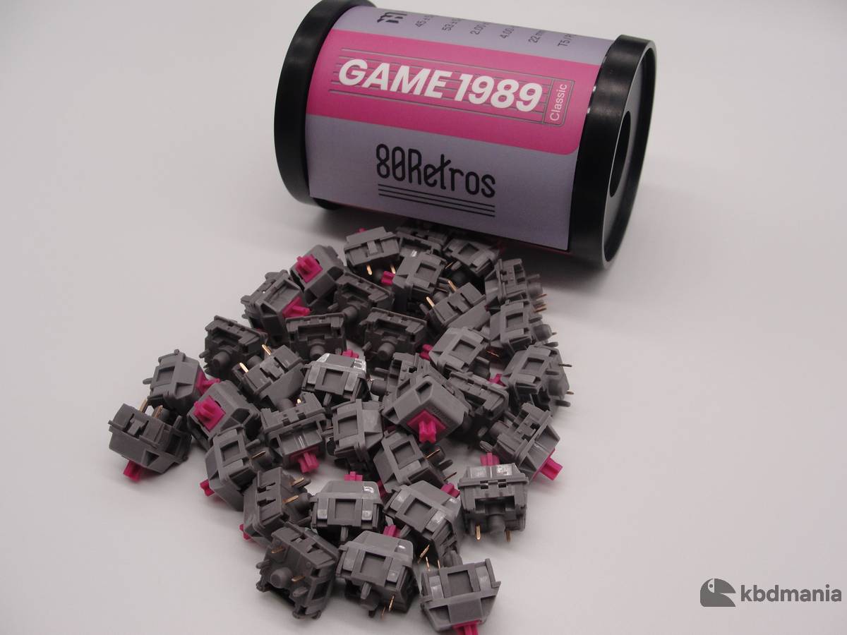 Pack switches HMX Game 1989, lineales, stem fuccia, top y bottom gris oscuro.